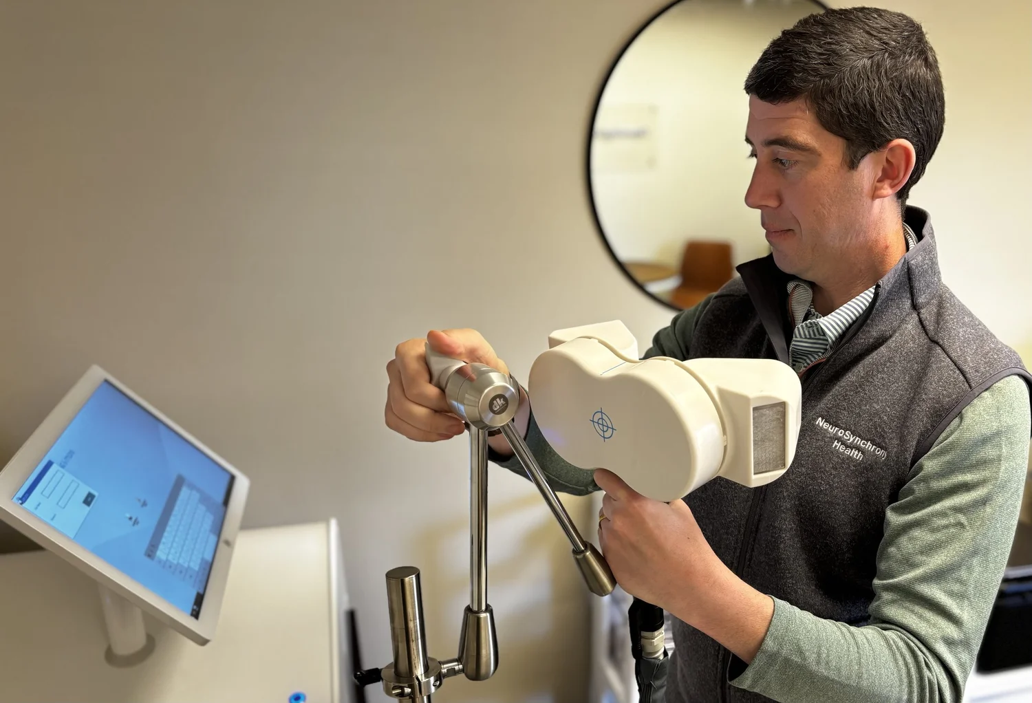 NeuroSynchrony clinician preparing a TMS coil